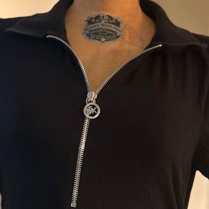 Worn few times.Michael Kors size m black zippered top.